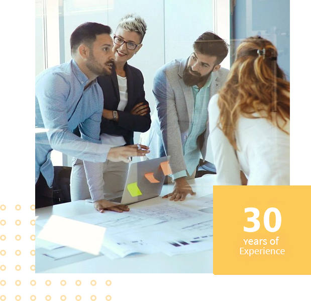 Team collaborating around a table, 30 years experience.